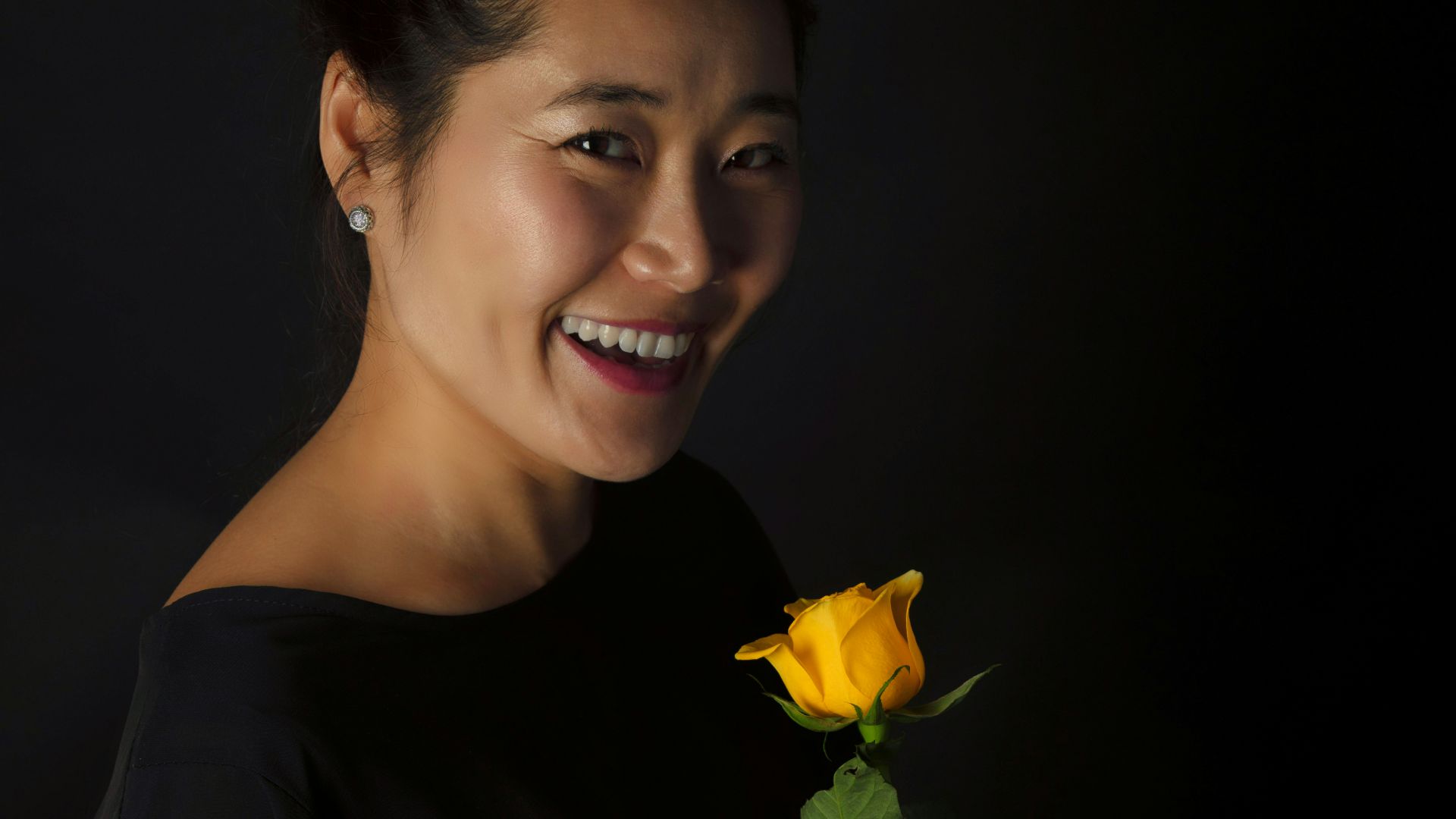a person holding a yellow flower