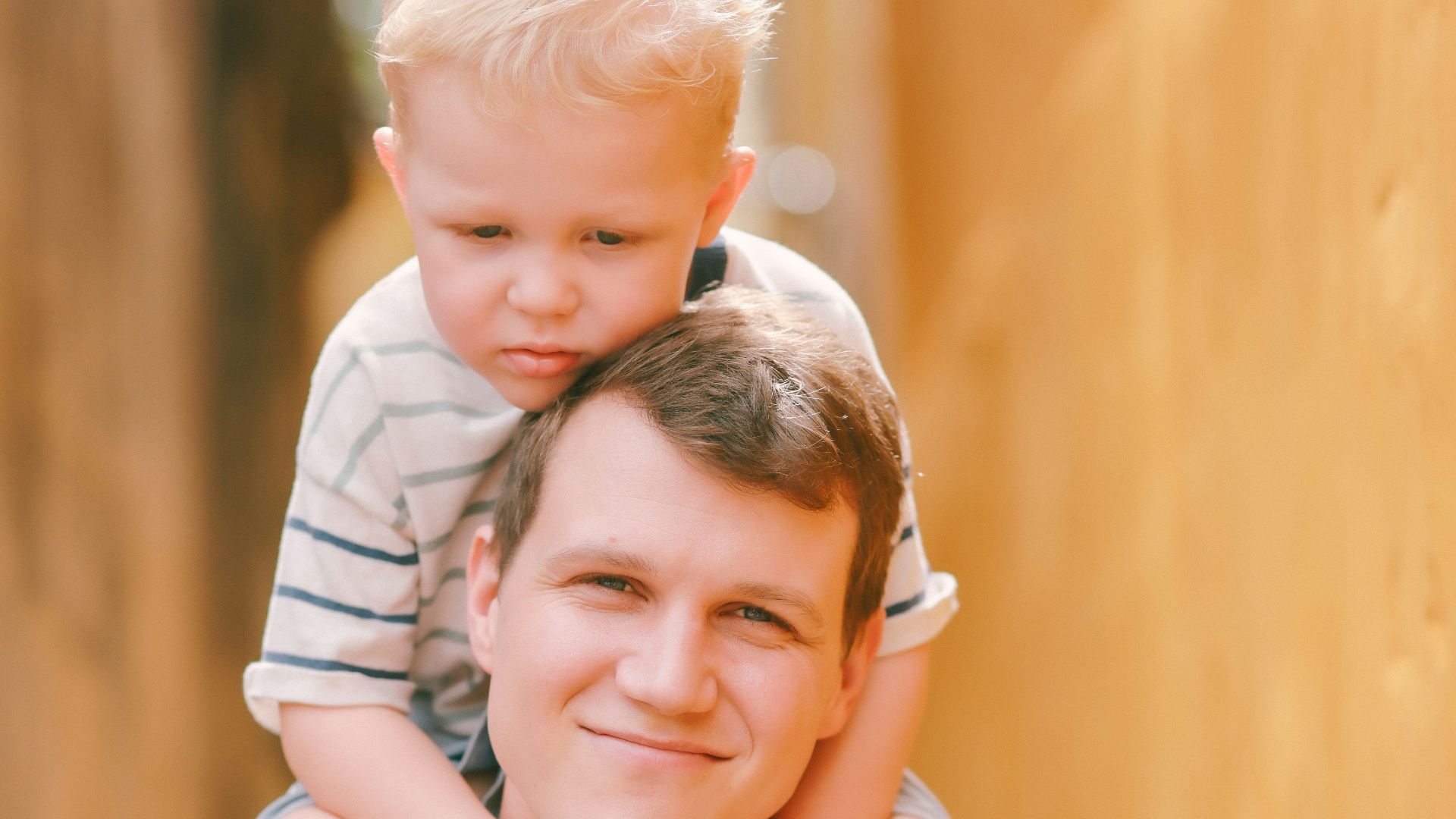 Father carrying his son on his shoulders outdoors