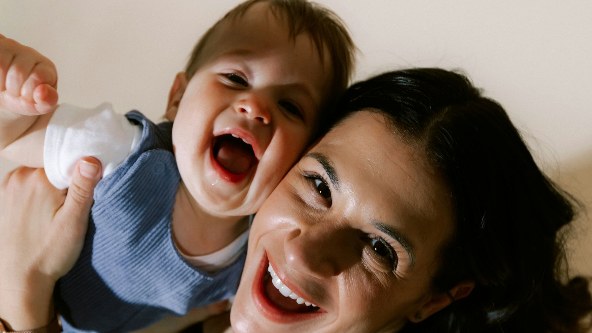 Mother and baby laughing together joyfully
