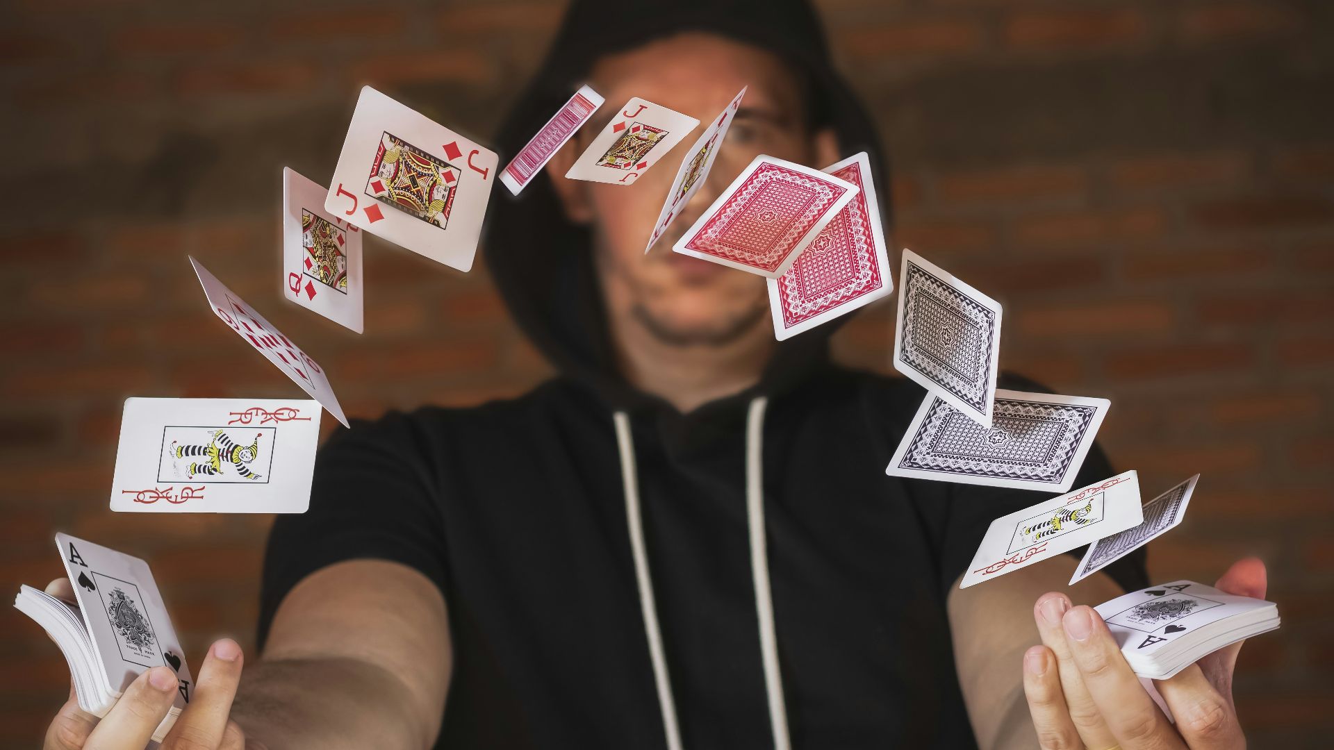 woman in black and white crew neck t-shirt holding playing cards