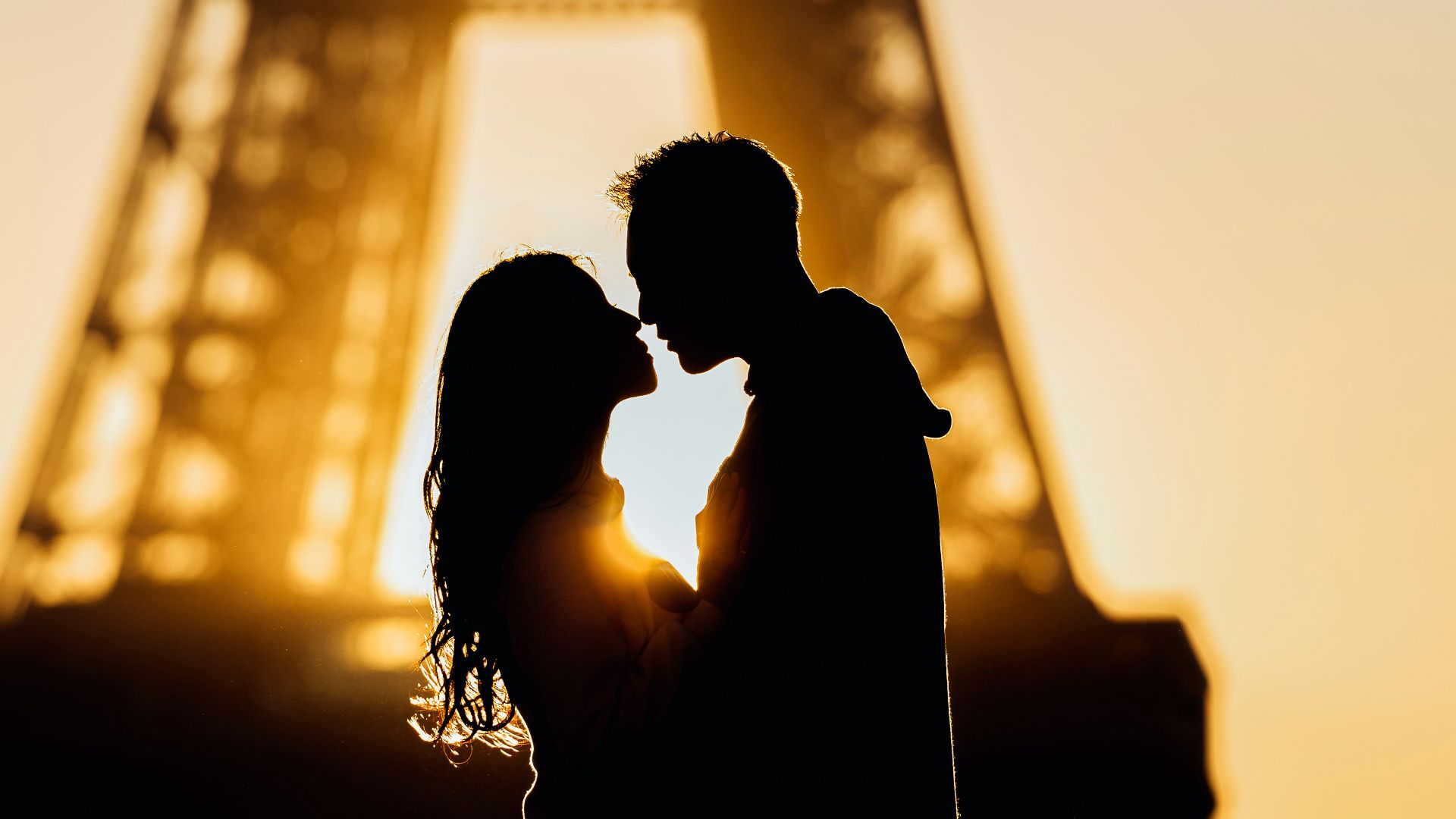 silhouette of man and woman kissing during sunset