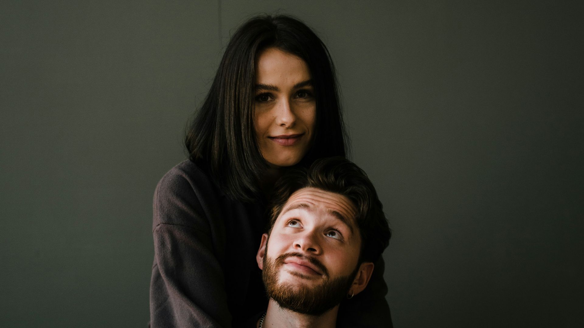 man in black crew neck shirt beside woman in black long sleeve shirt