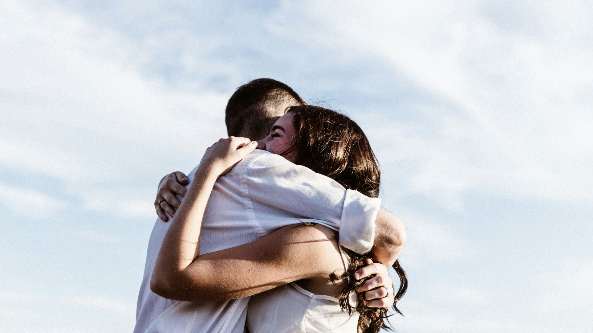 man and woman hugging each other photography