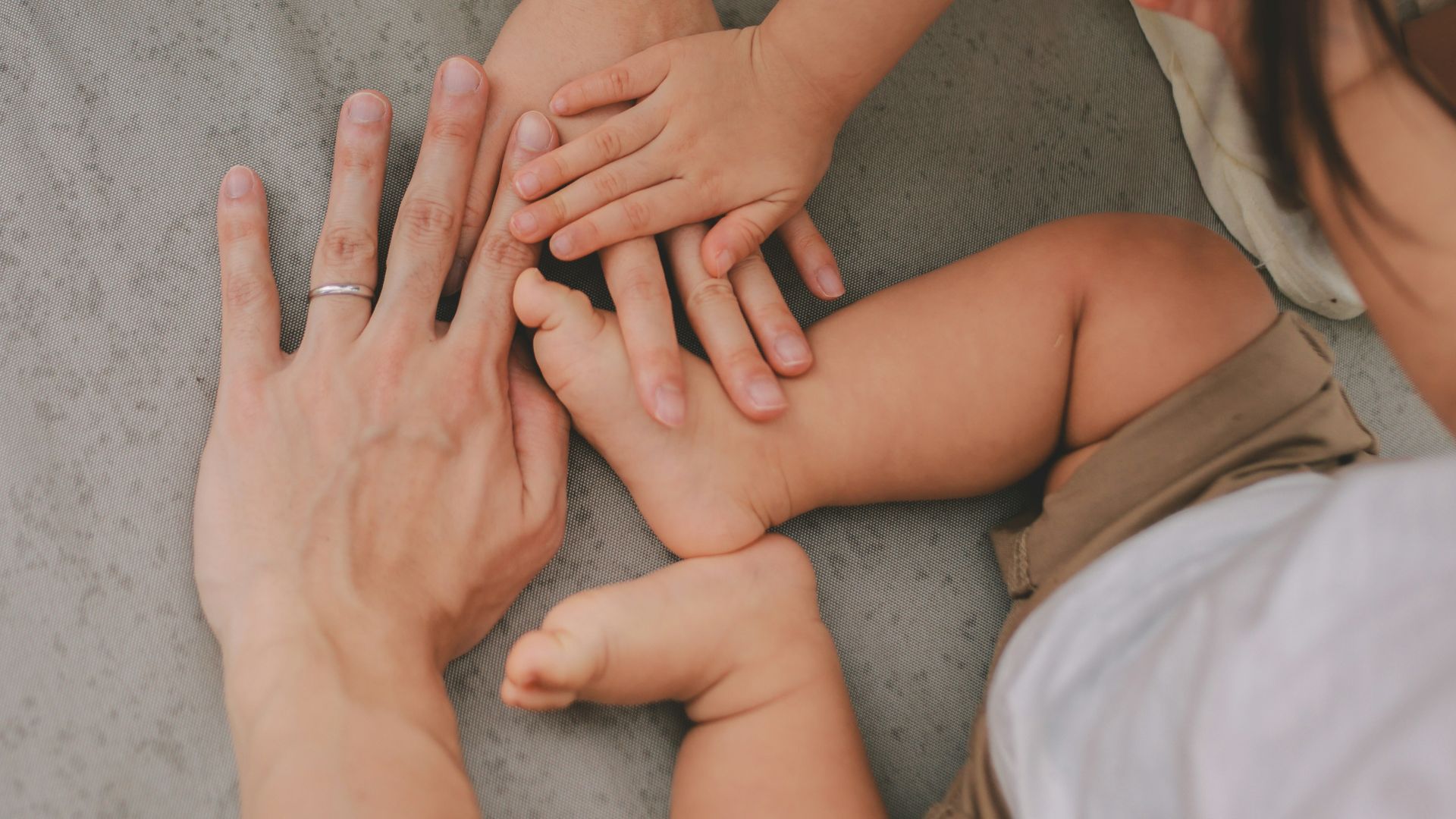 Family members stacking hands together in unity