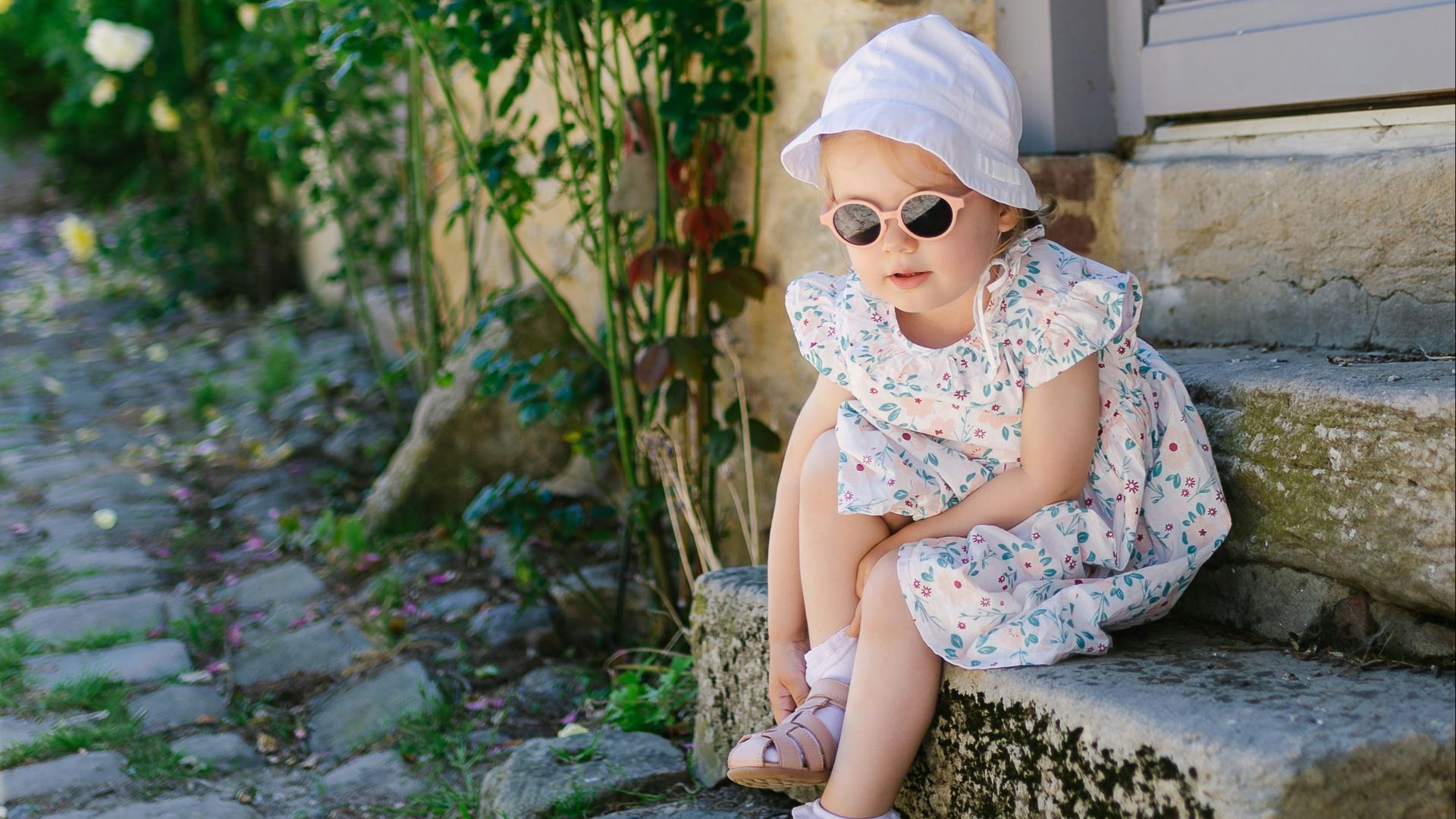a little girl that is sitting on some steps