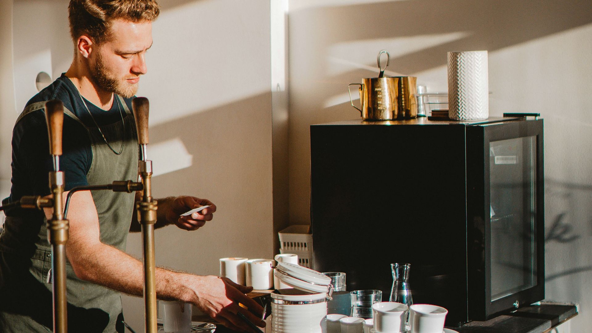 man in black and white polo shirt playing guitar
