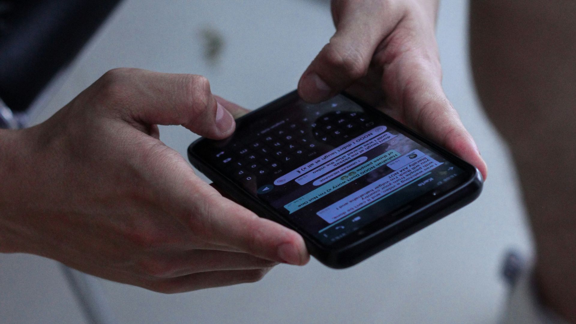 person holding black iphone 4