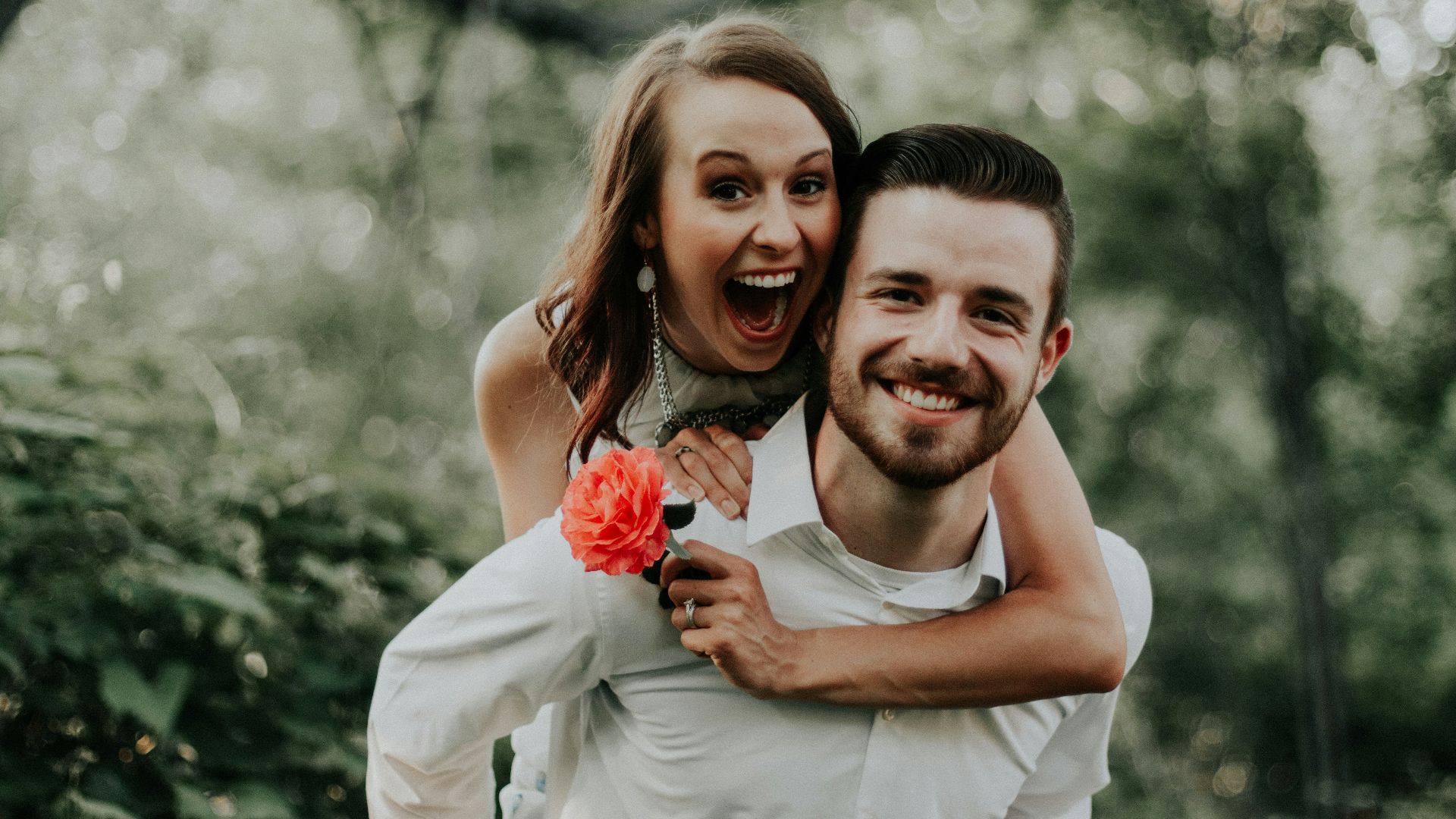 woman riding on back of man
