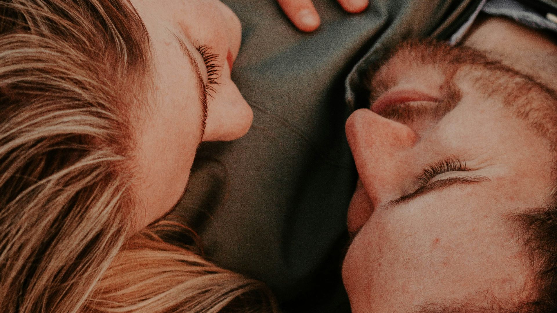 a woman stares into a man's eyes lovingly