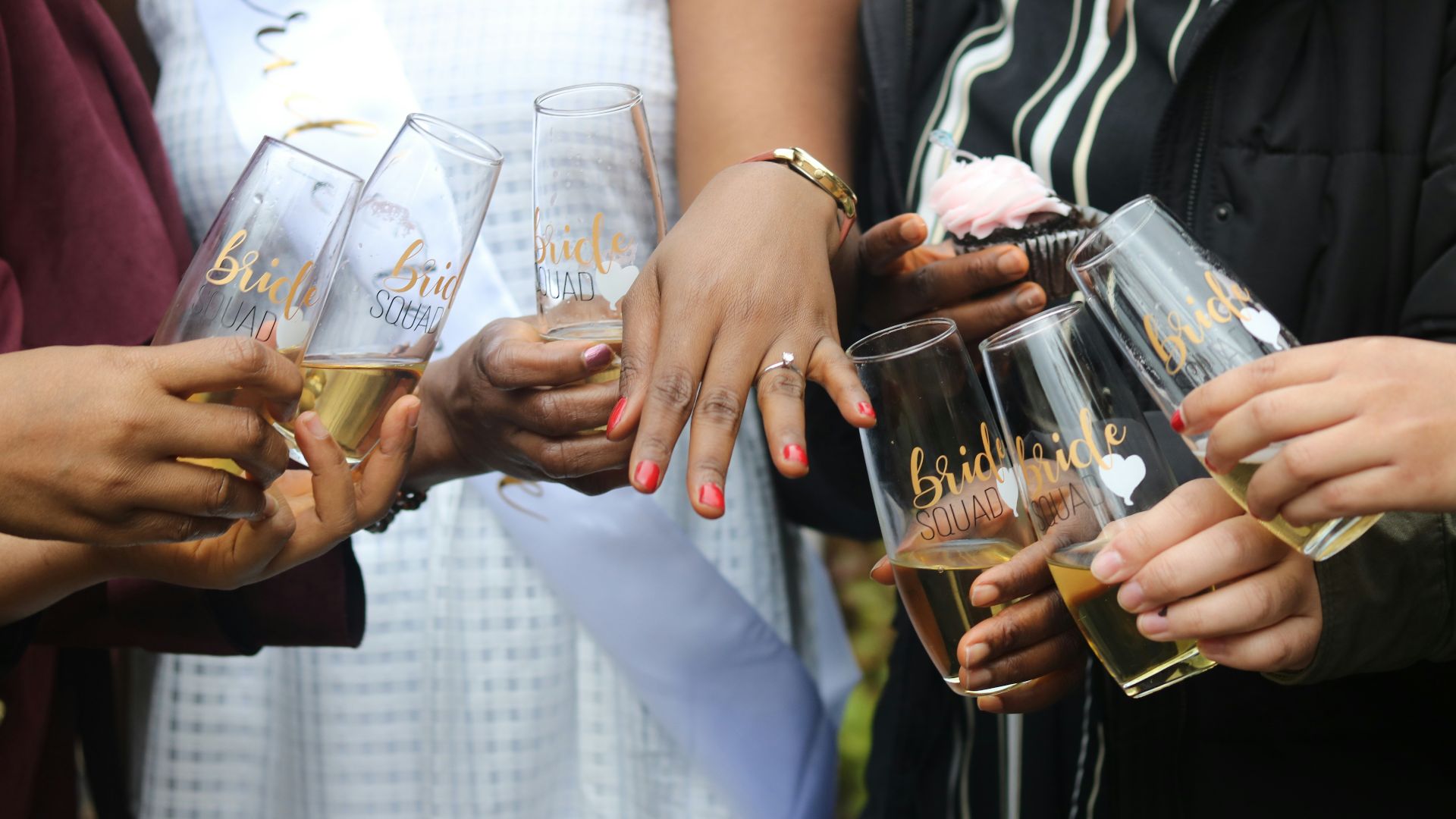 a group of people holding wine glasses in their hands