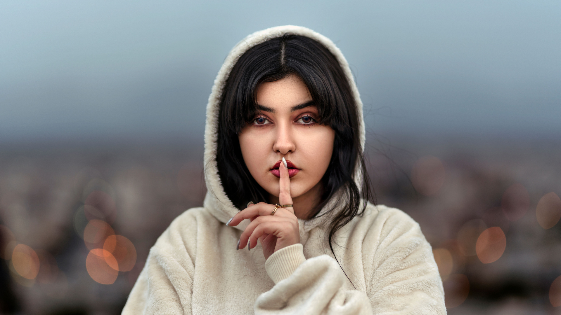 lady-holding-finger-to-mouth-thumb-rss.png