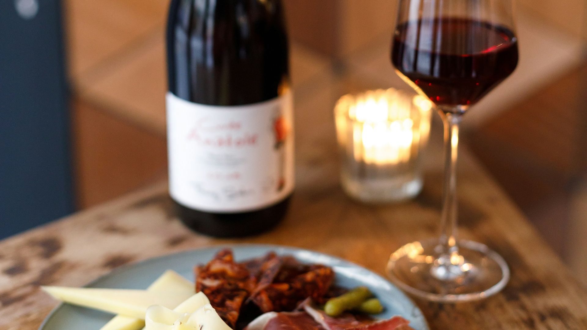 a plate of food and a glass of wine on a table