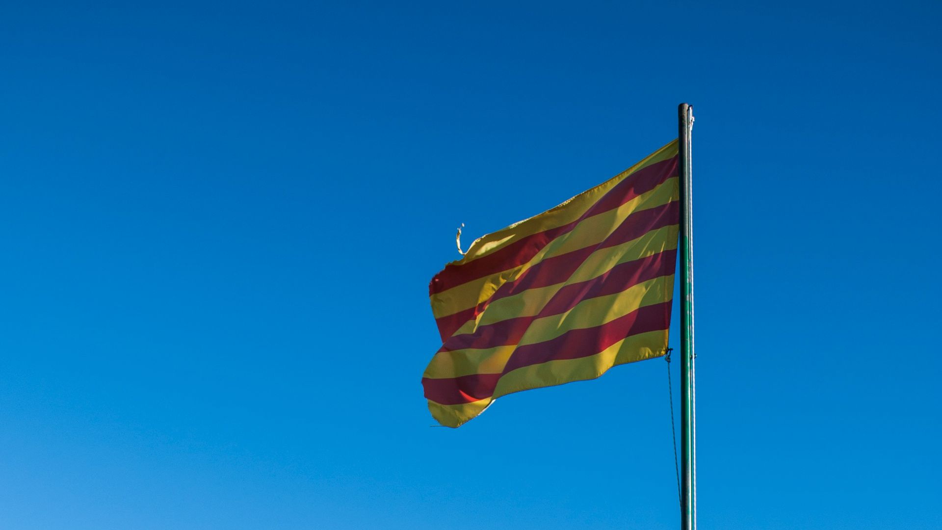 a flag on top of a rocky hill