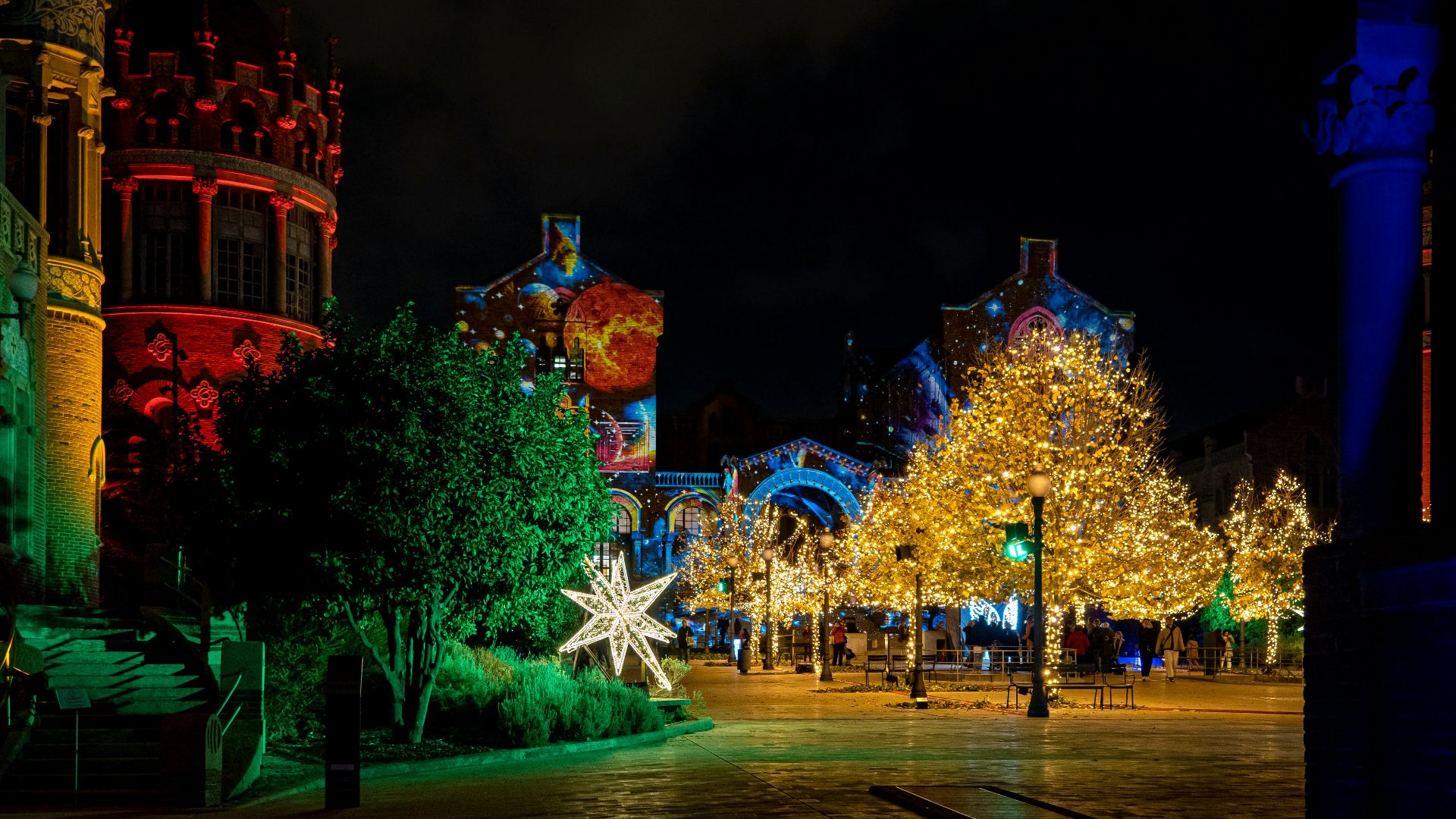 a city street at night decorated with christmas lights