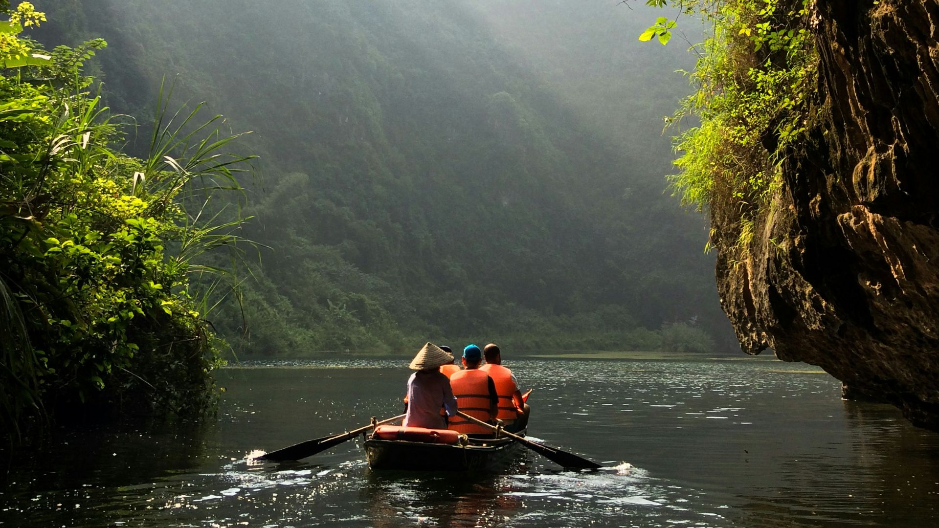 group of people on boat paddling during daytime