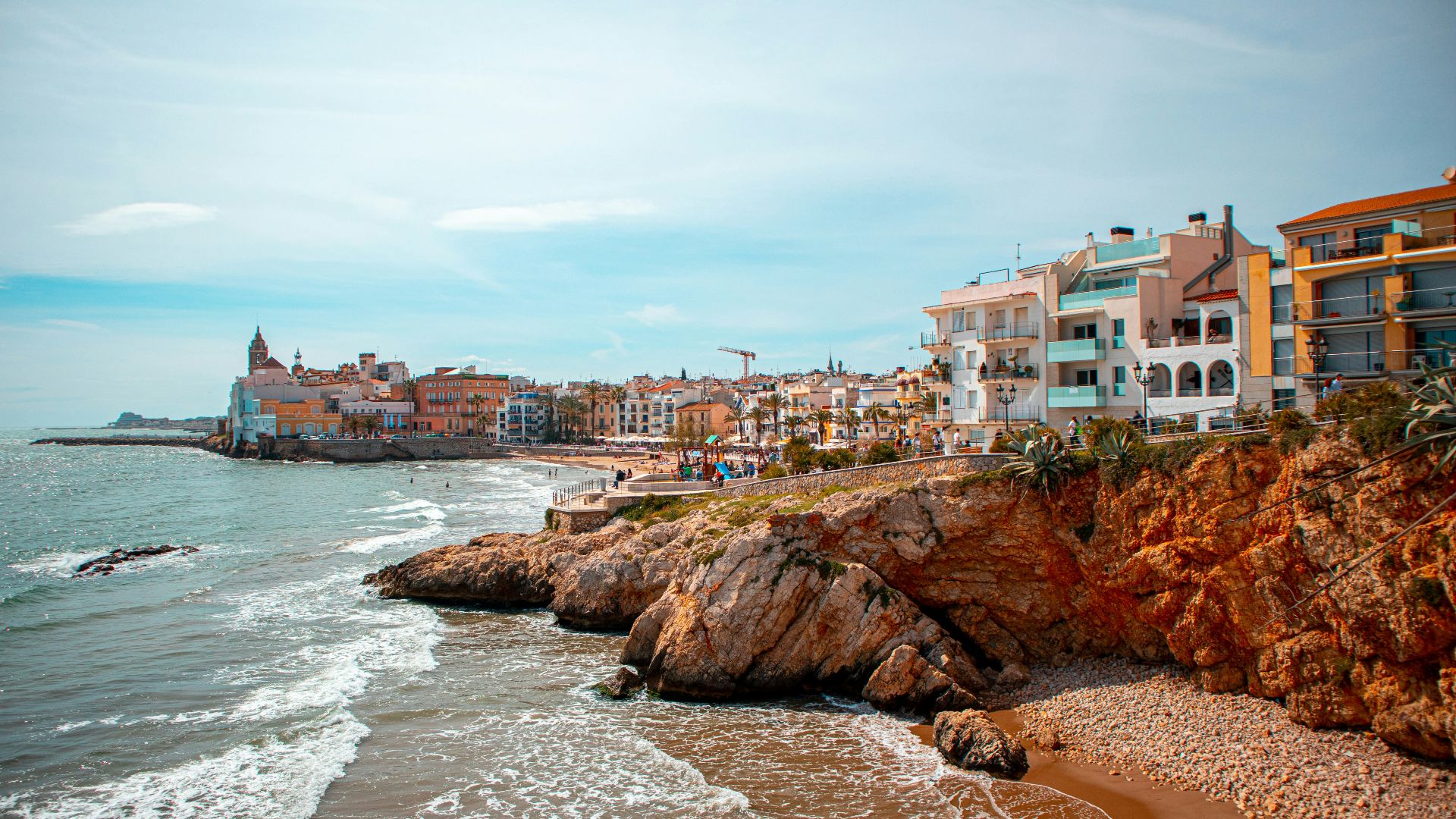people on beach near buildings during daytime
