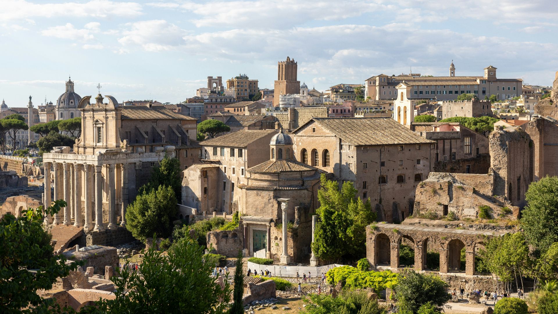 a large city with many buildings with Roman Forum in the background