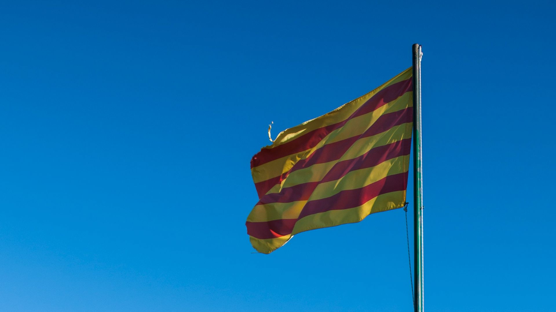 a flag on top of a rocky hill