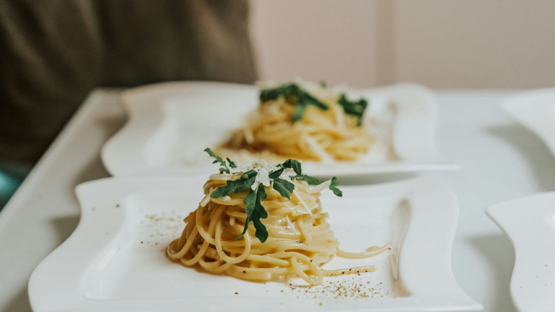 a person holding a knife over a plate of food