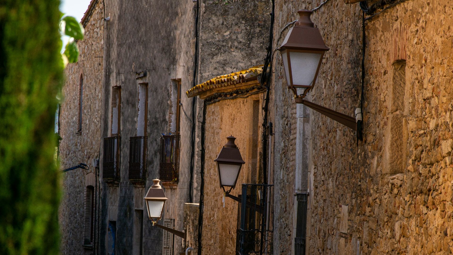 a cobblestone street lined with stone buildings