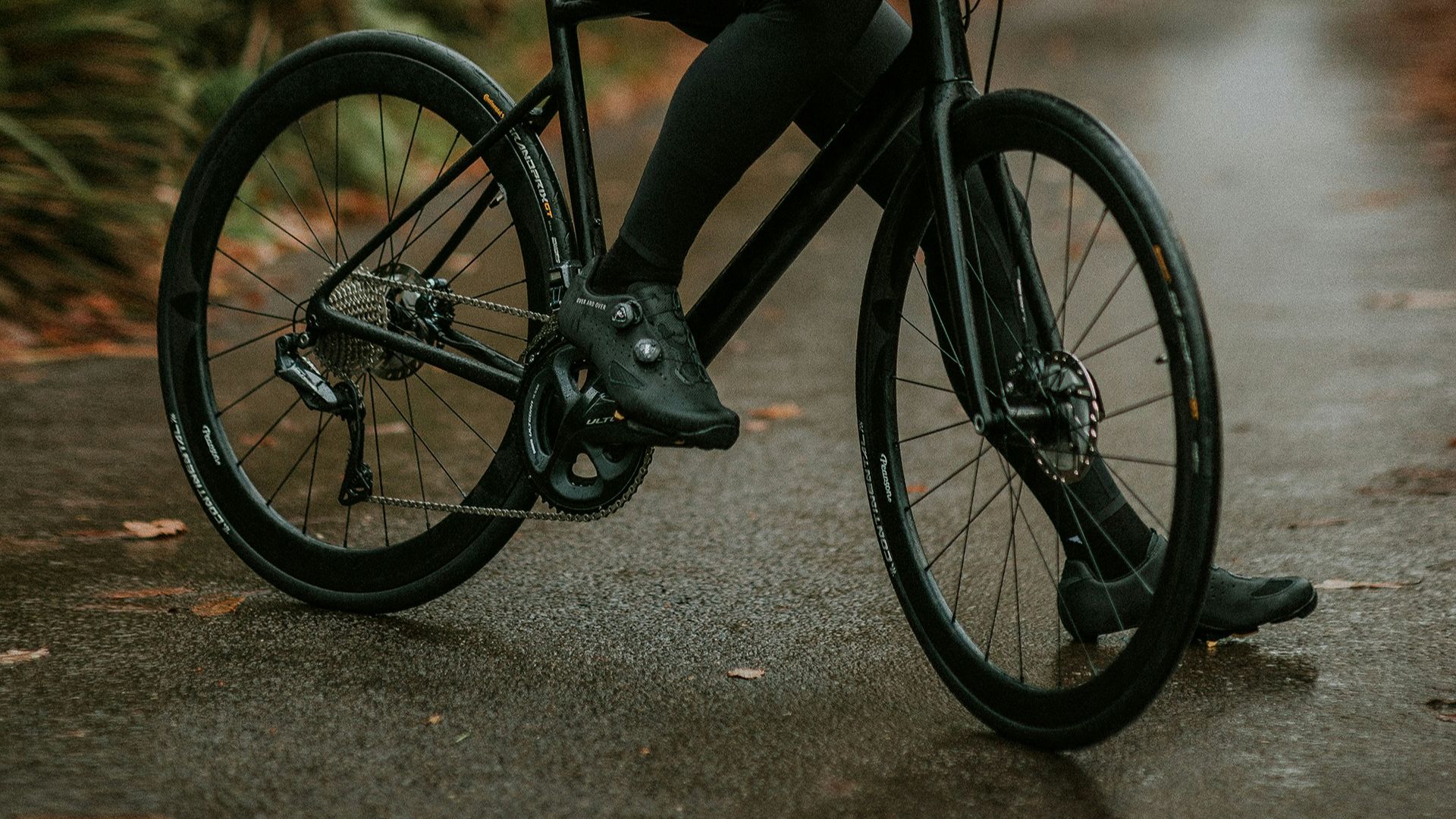 man sitting on road bike near trees
