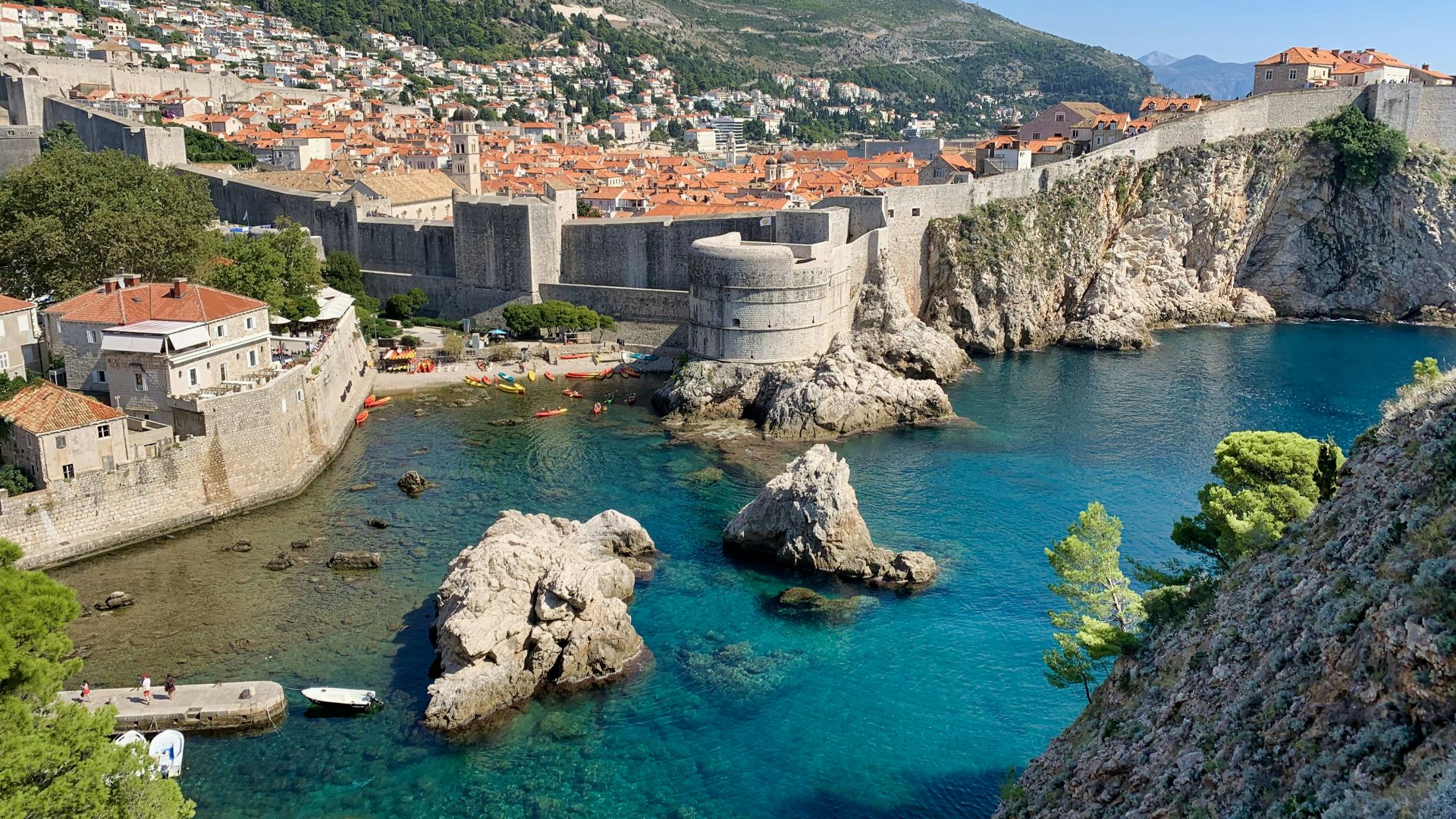 white and brown concrete building near body of water during daytime