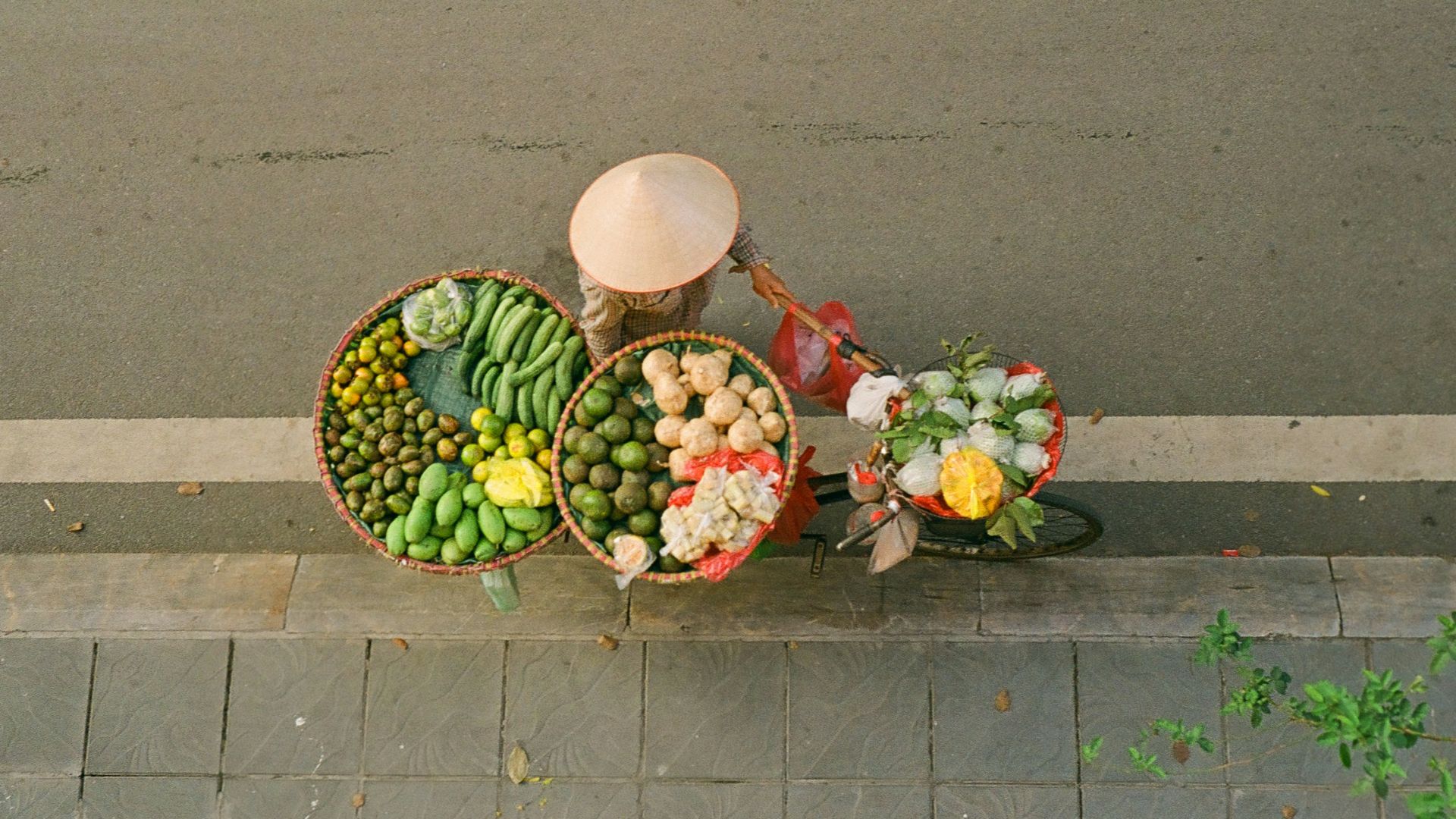 A couple of baskets of food sitting on the side of a road