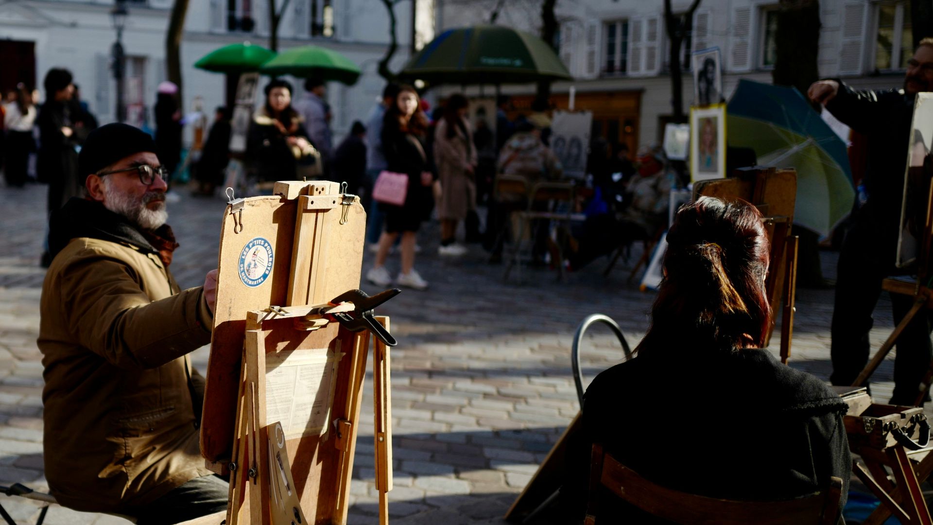people sitting on chair near road during daytime