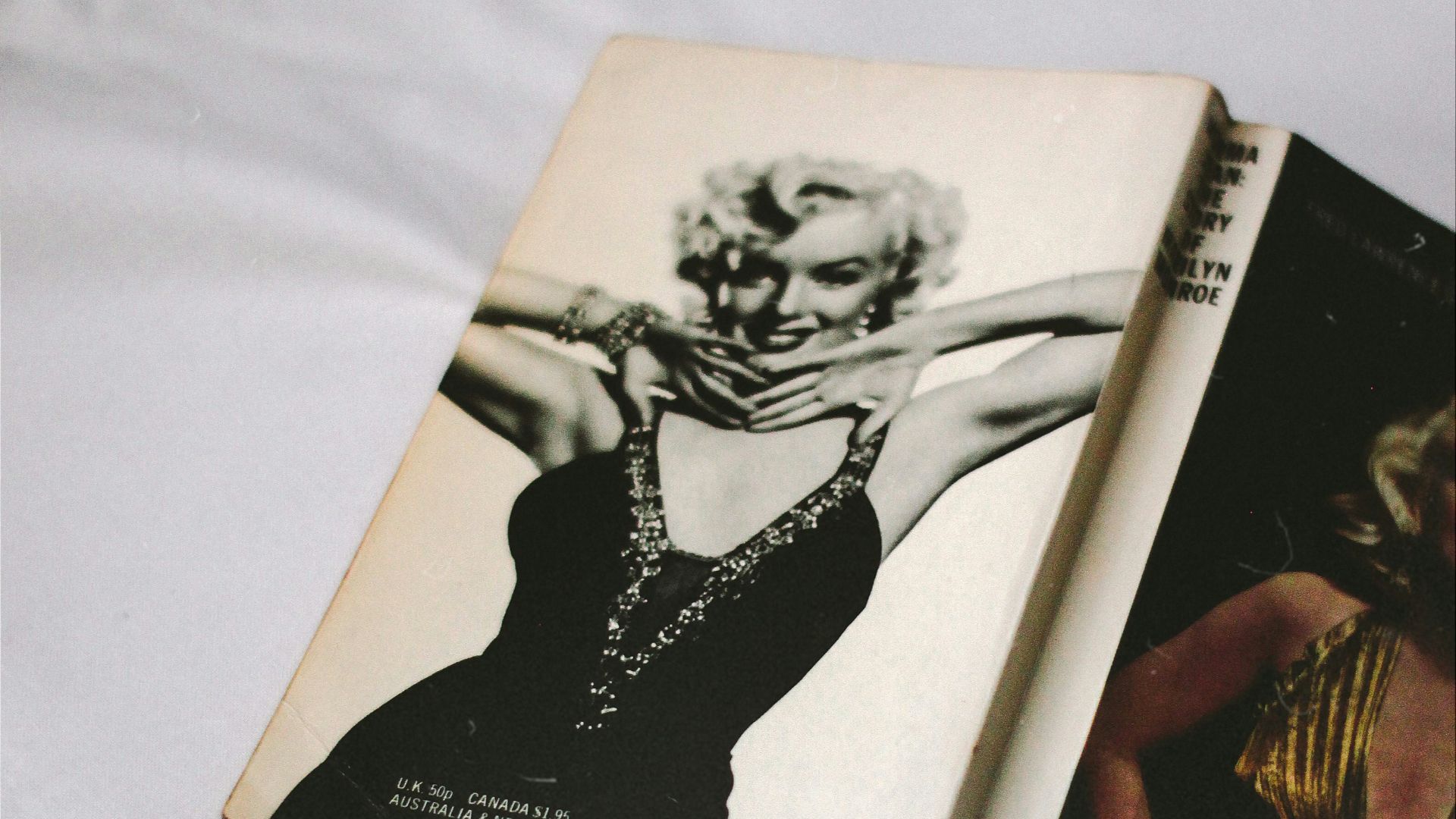 black and white book on white textile