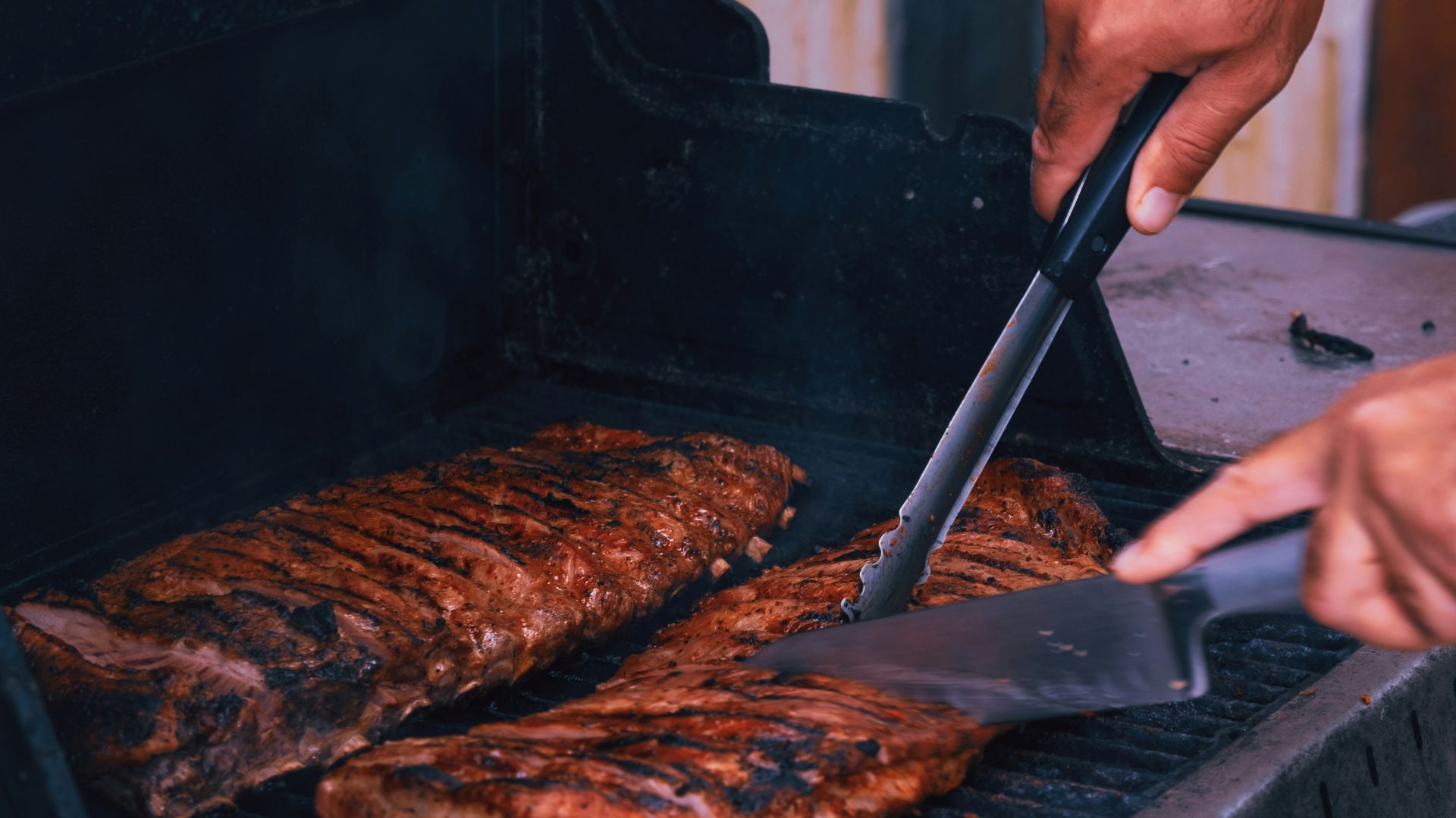 a man is grilling some meat on a grill