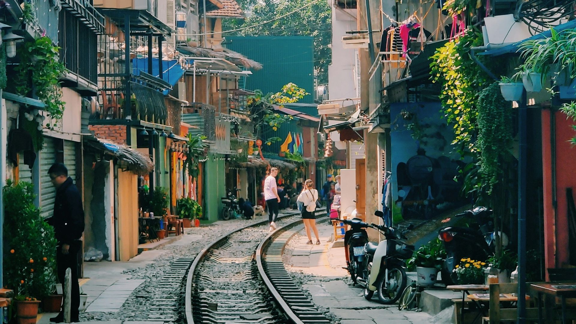 people walking on sidewalk near buildings during daytime
