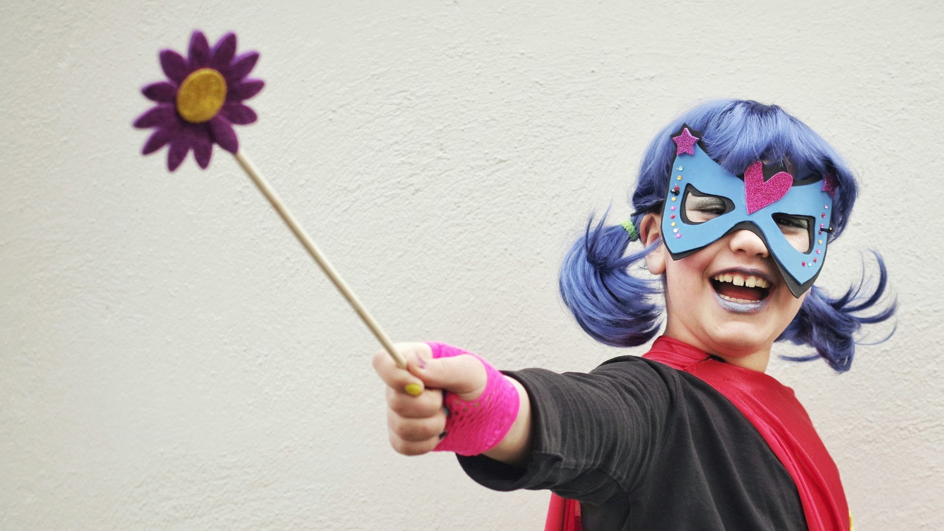 woman in black and red long sleeve shirt with blue and purple hair