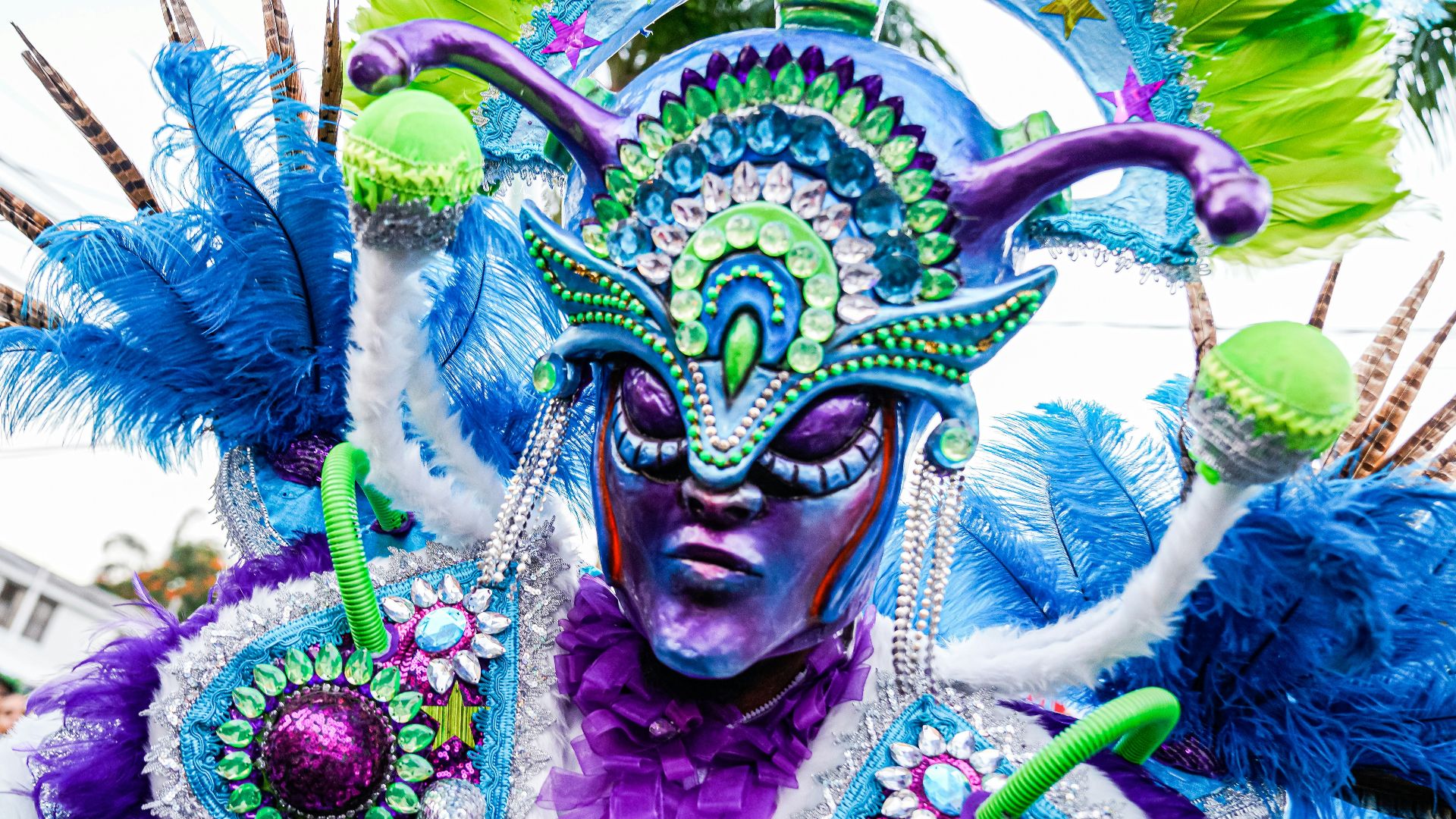 a man in a colorful costume with feathers on his head