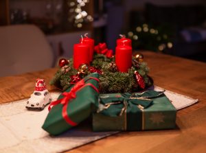 unlighted-red-advent-candles-on-table-beside-green-gift-1746191-300x223.jpg