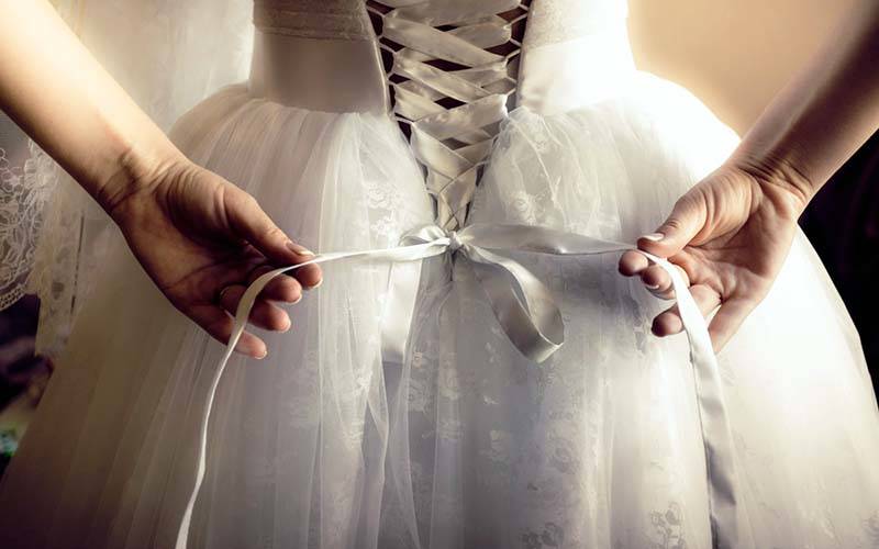 10-bride-tying-up-her-wedding-dress.jpg