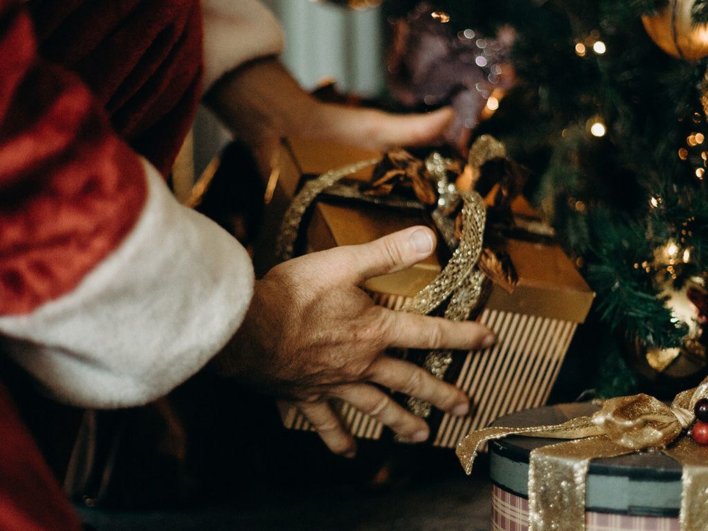 resizeperson-wearing-santa-costume-holding-gold-gift-box-3149898.jpg.optimal.jpg