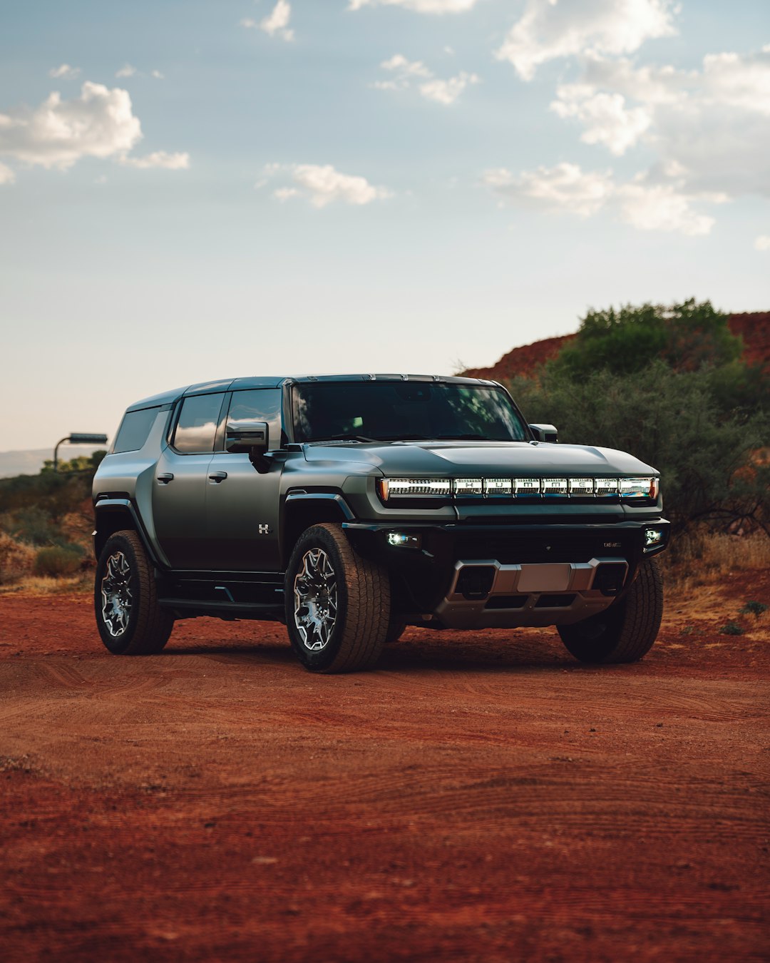 A silver truck parked on a dirt road
