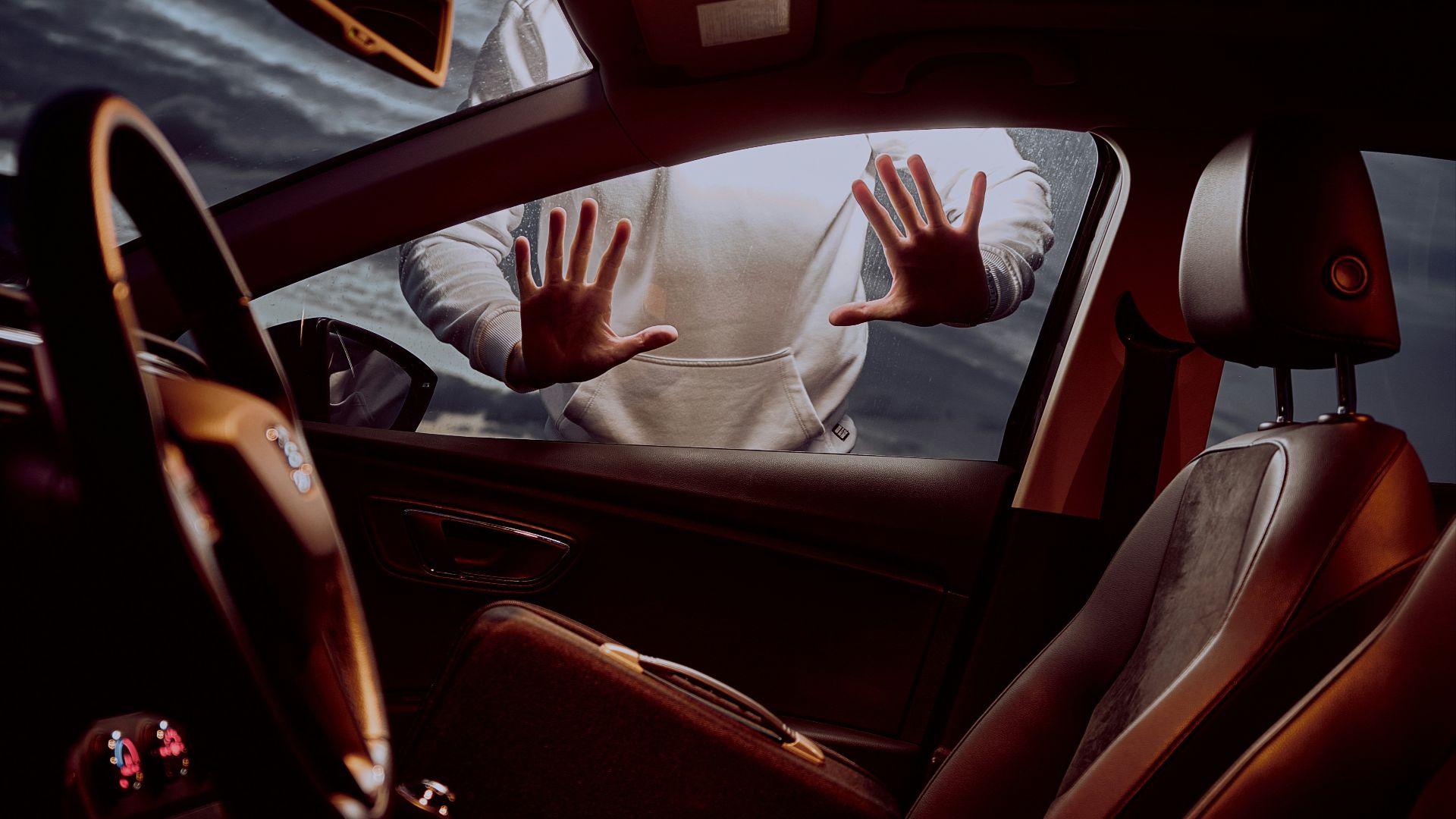 man in white long sleeve shirt driving car