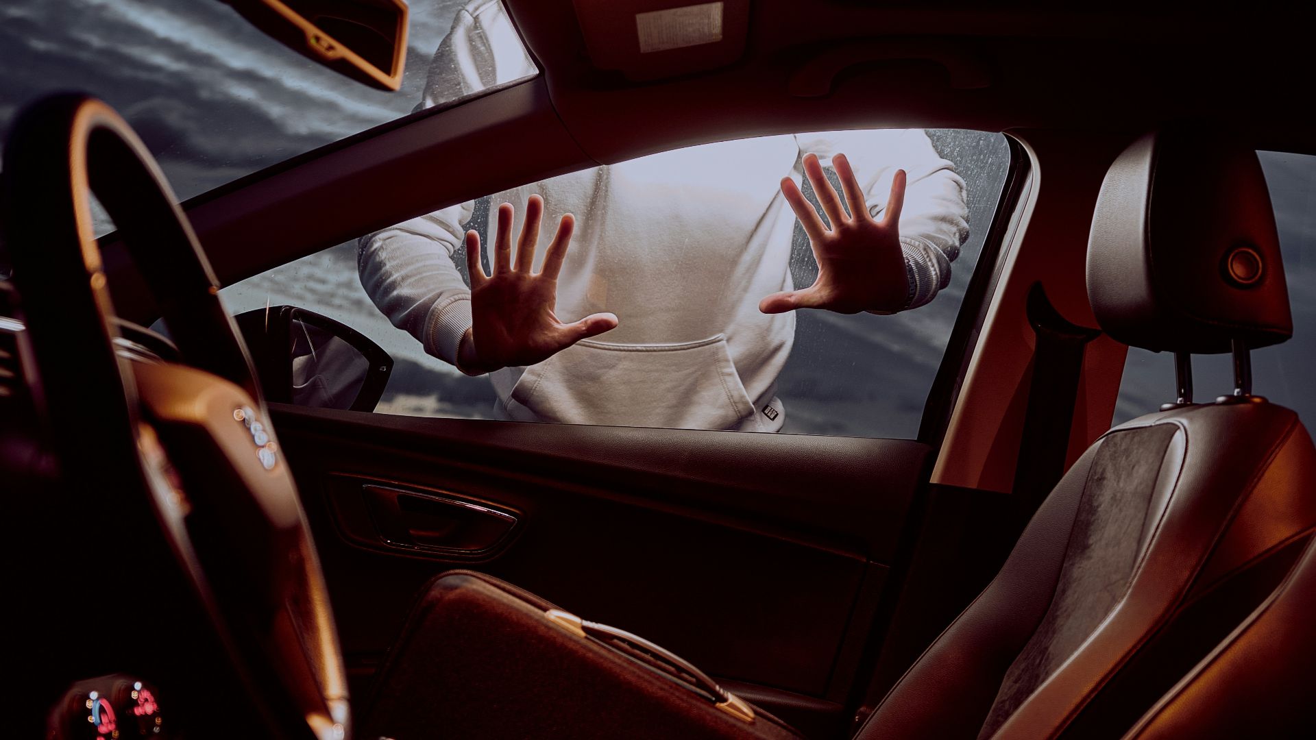 man in white long sleeve shirt driving car