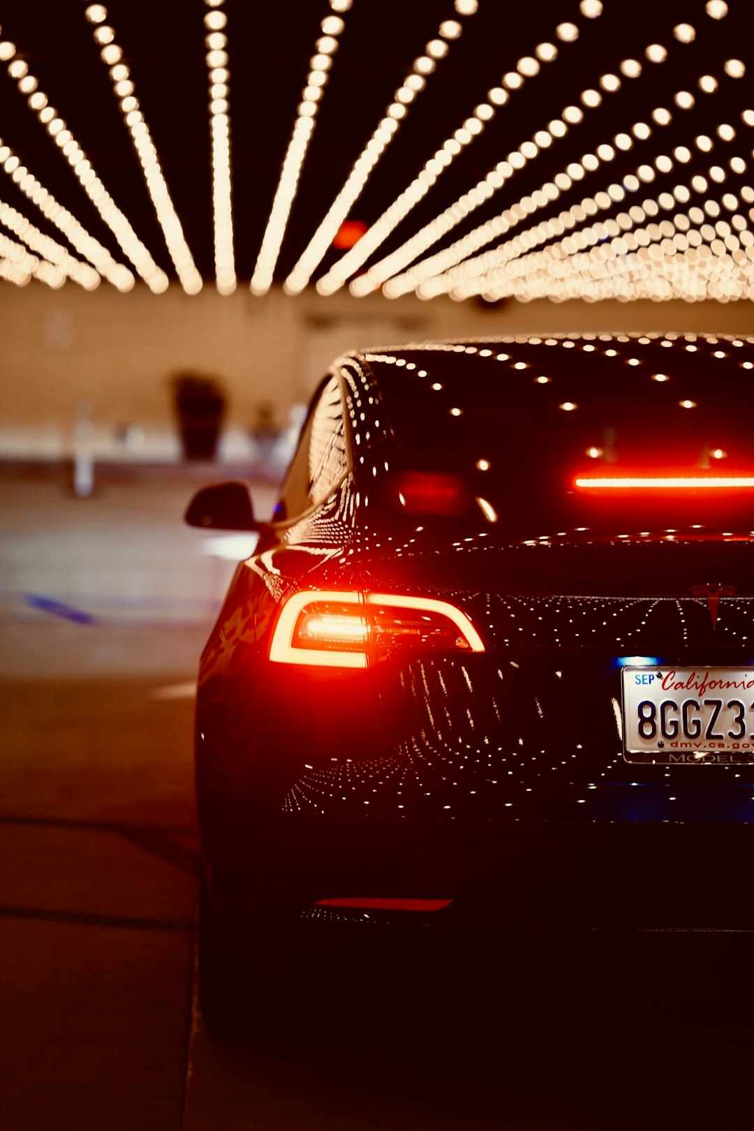 a car parked in front of a building with lights