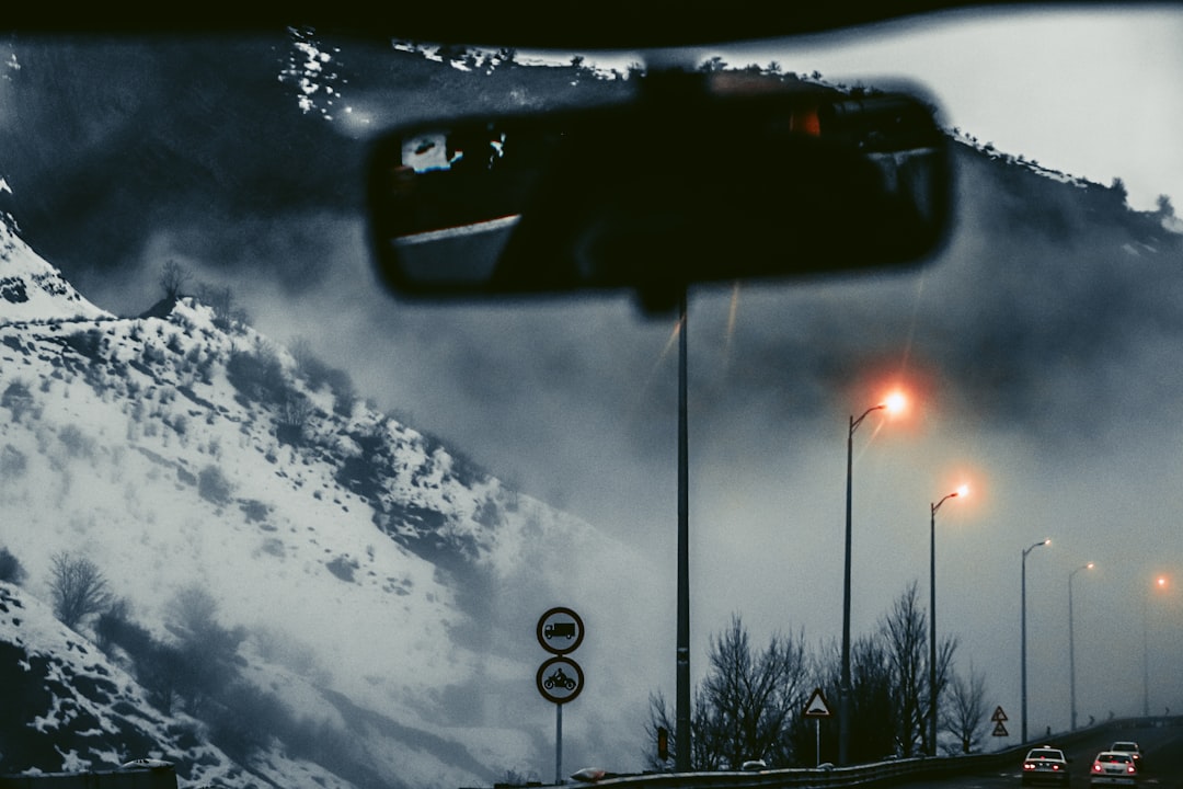 A view of a snowy mountain from a car window