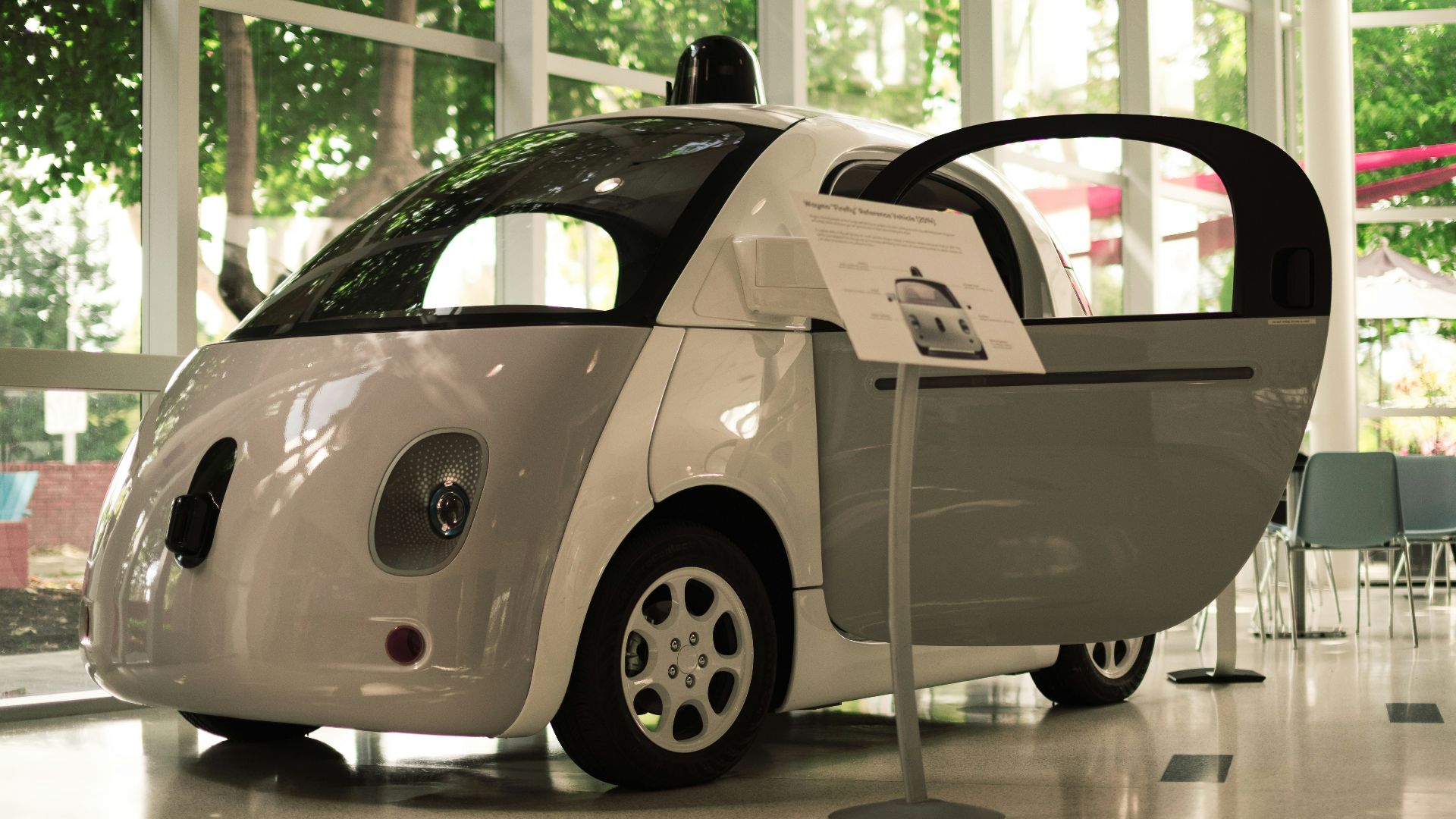 a small white car parked in a room