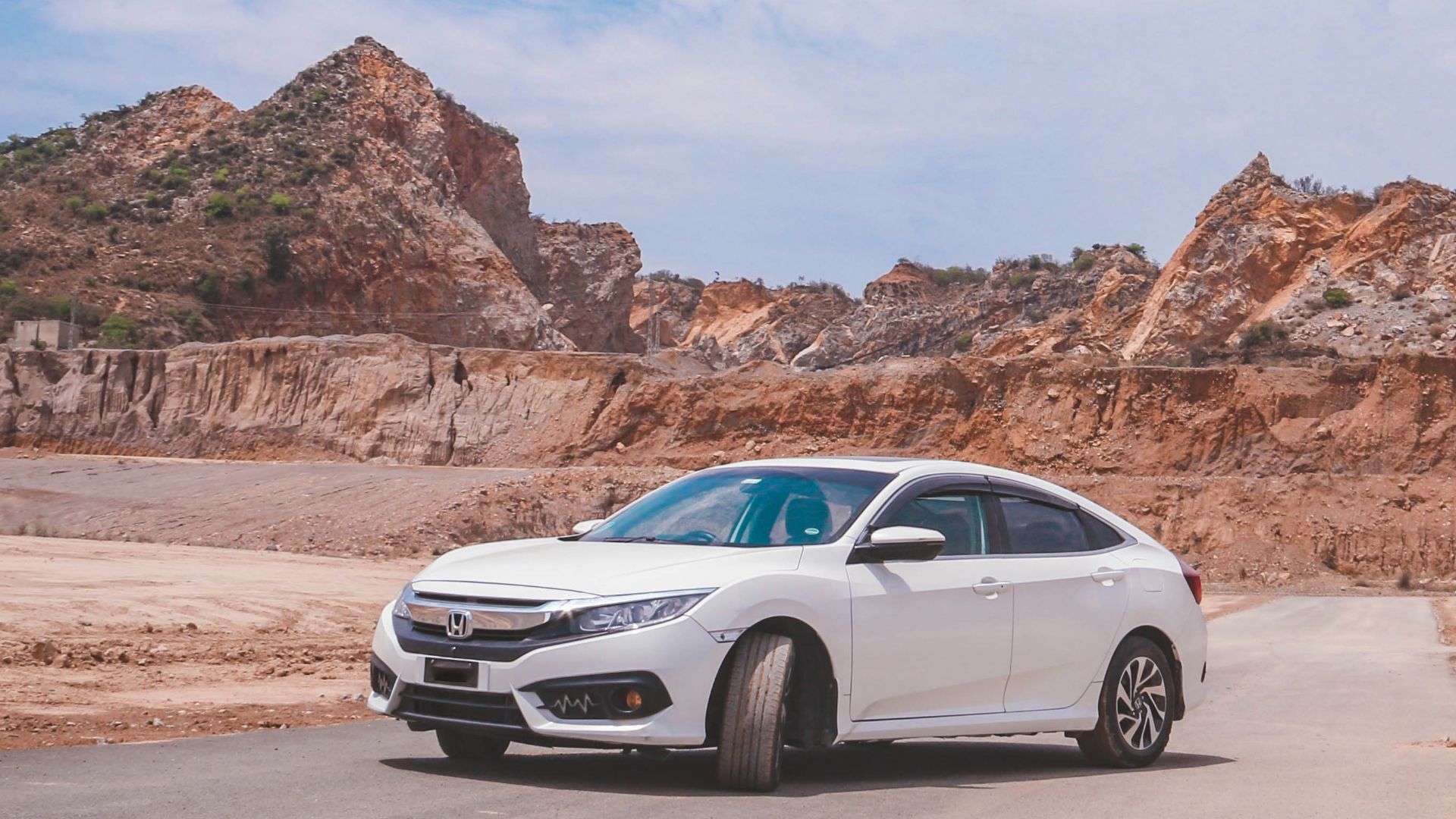 a white car parked on the side of a road