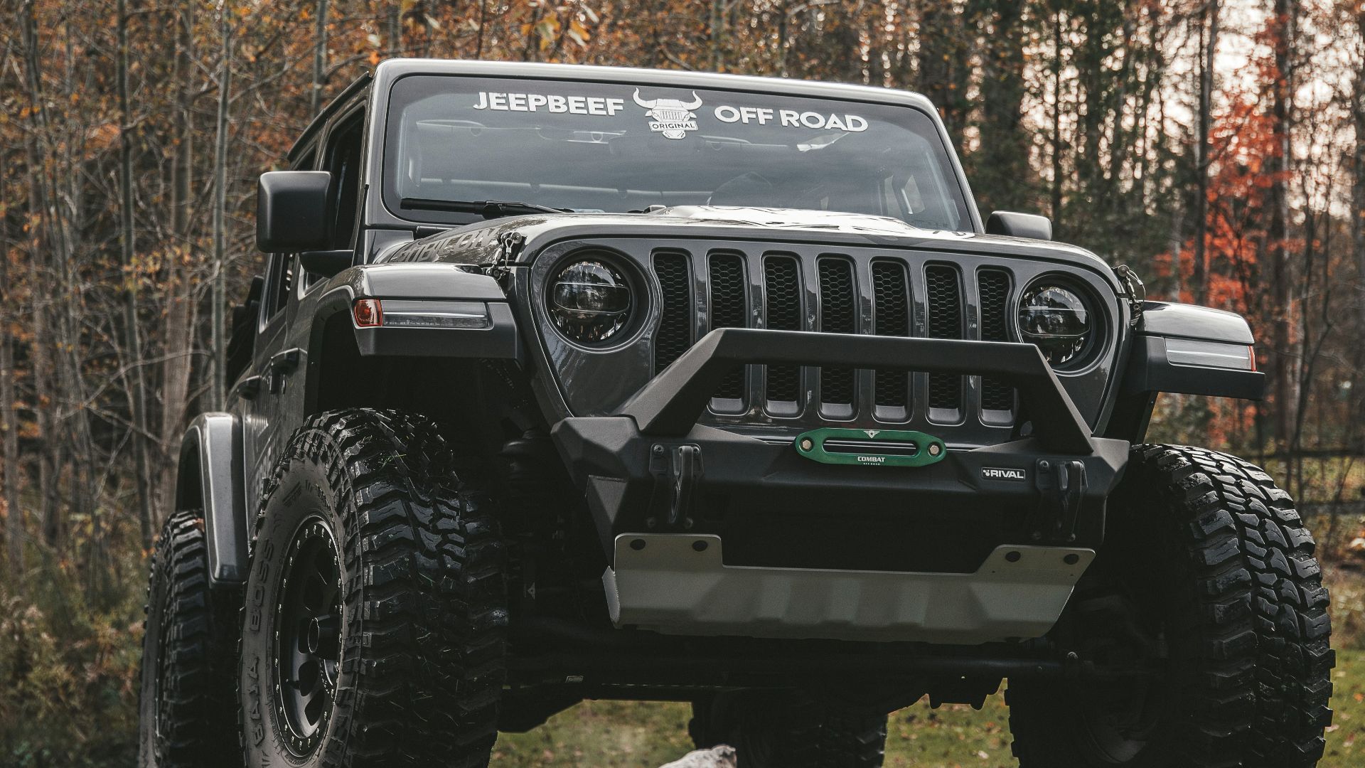 a black jeep is parked in the grass