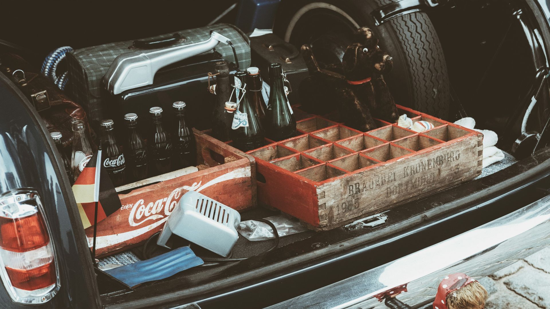 The back of a car with a bunch of tools in the trunk