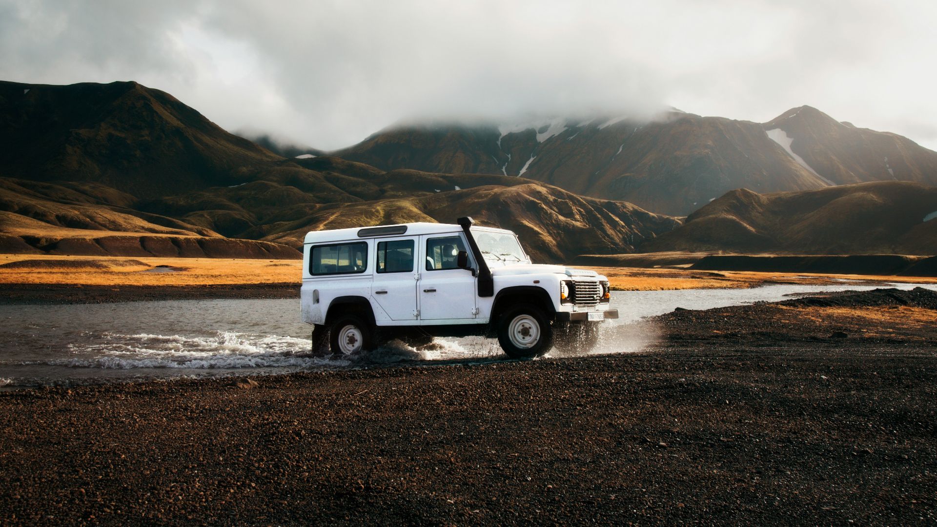 white car crossing body of water