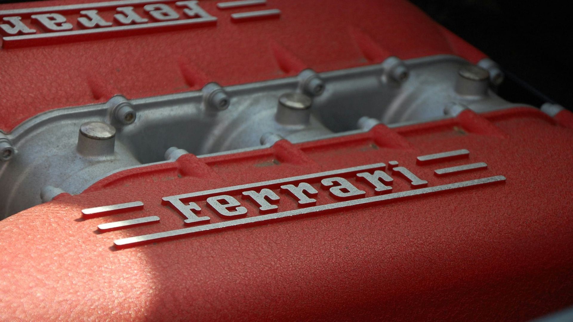 close-up photography of gray and red Ferrari engine