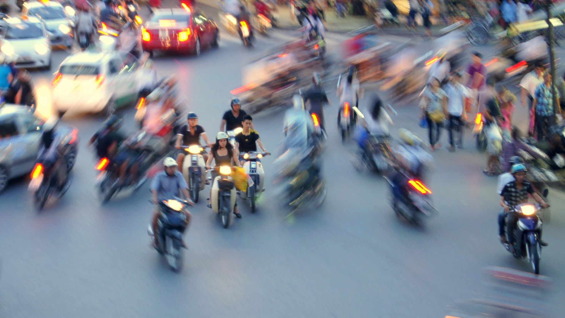 a blurry photo of a busy street filled with motorcycles