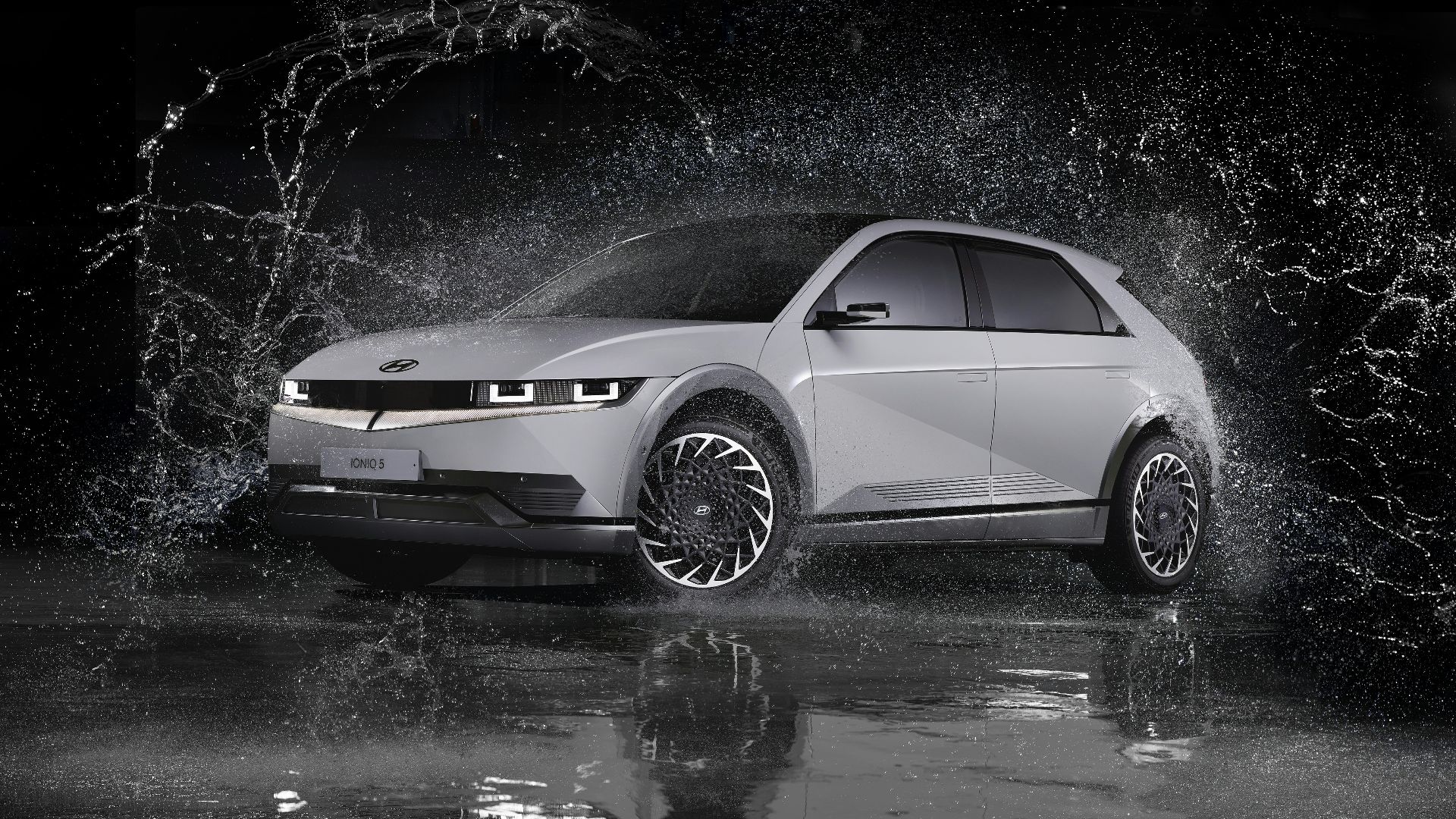 a white car is splashing in the water