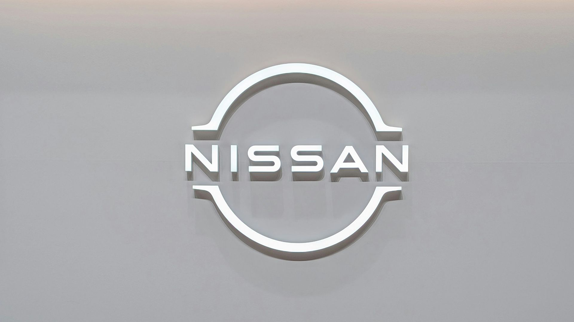 a conference room with a nissan logo on the wall
